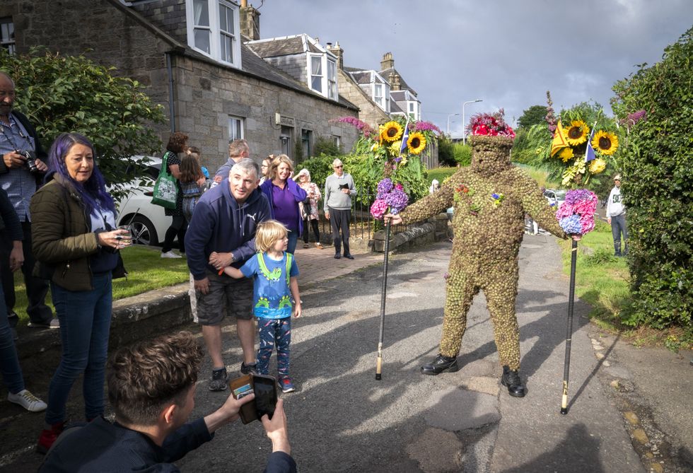 Burryman Andrew Taylor parades through the town of South Queensferry (Jane Barlow/PA)