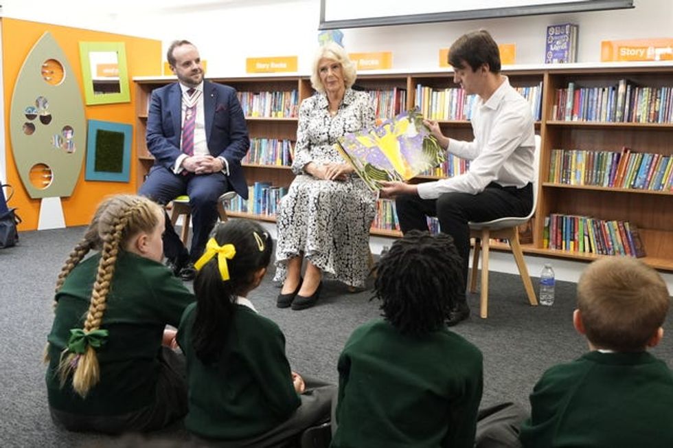Camilla and others listen to a book reading