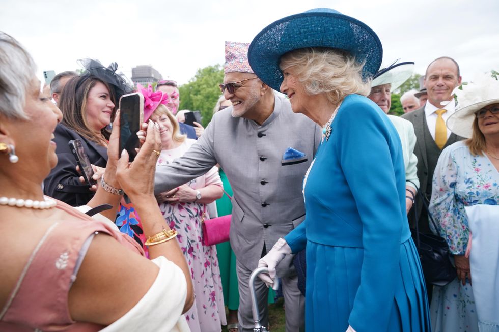 Camilla makes friends with ‘attention-seeking’ guide dog at palace garden party