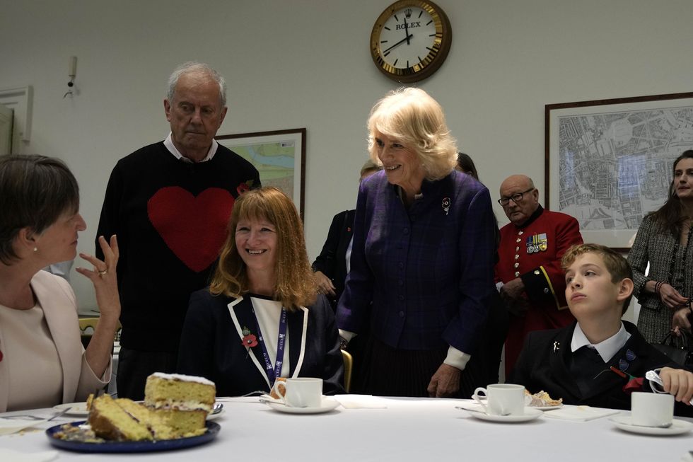 Camilla speaks to pupils and teachers at the Poetry Together tea party (Frank Augstein/PA)