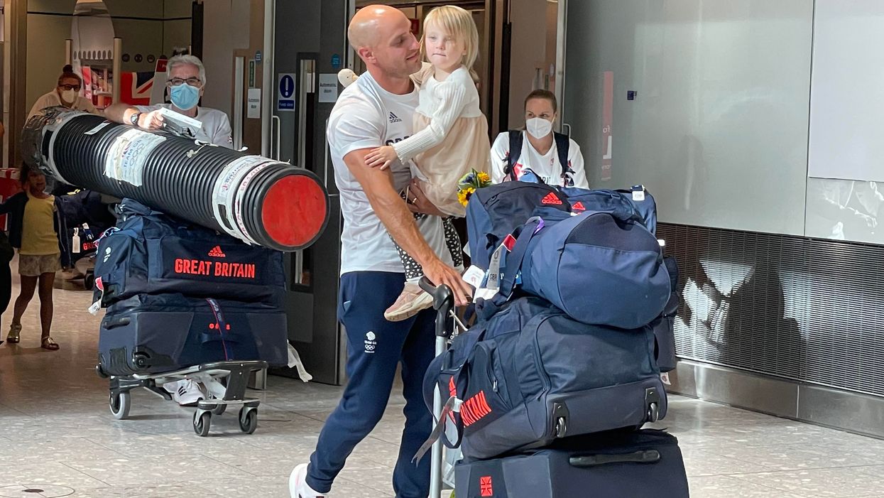 Canoeist Liam Heath is reunited with his three-year-old daughter Sarah at Heathrow Airport (Elmira Tanatarova/PA)