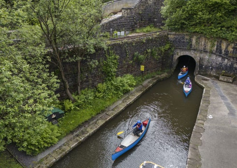 Canoeists exit the Standedge Tunnel on the Huddersfield Narrow Canal, described as one of the seven wonders of Britain\u2019s waterways