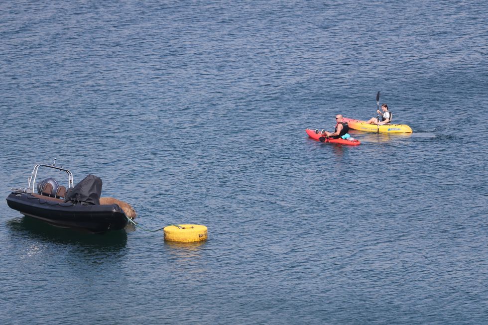 Canoeists row past Wally in Ardmore (Niall Carson/PA)