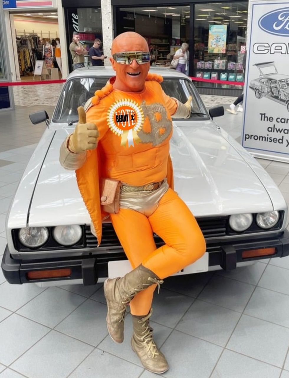 Captain Beany posing in front of a vintage car