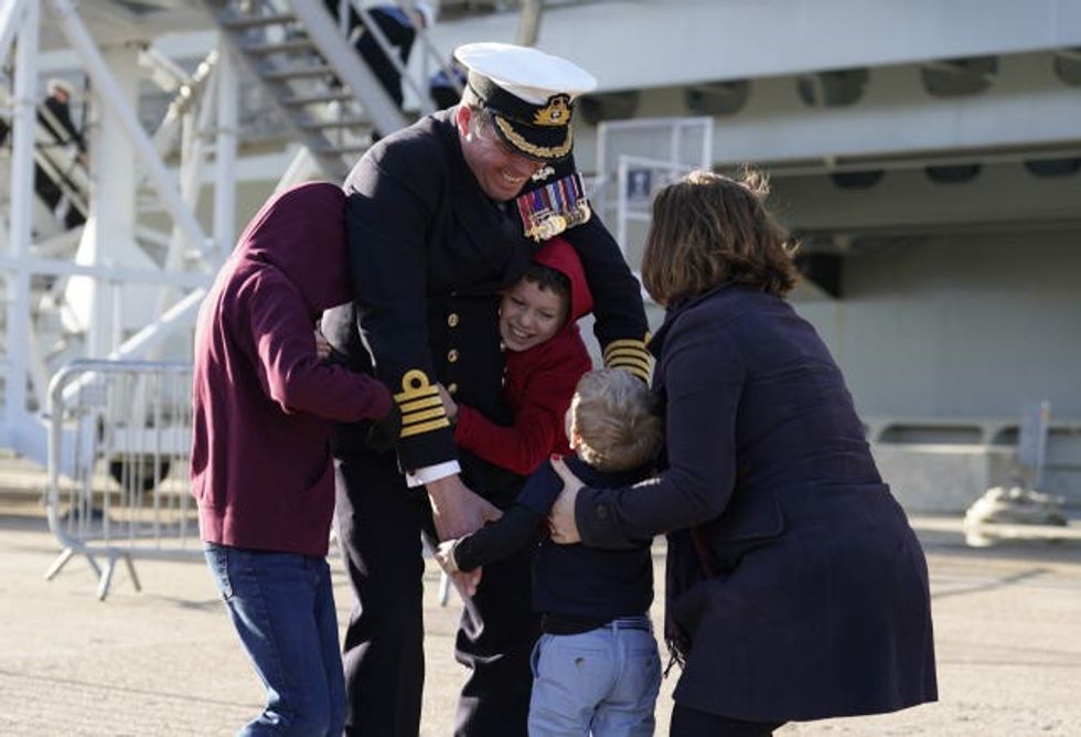 Captain Richard Hewitt, commanding officer of HMS Prince of Wales, is greeted by his wife Clara and their sons Oliver, William and Ben