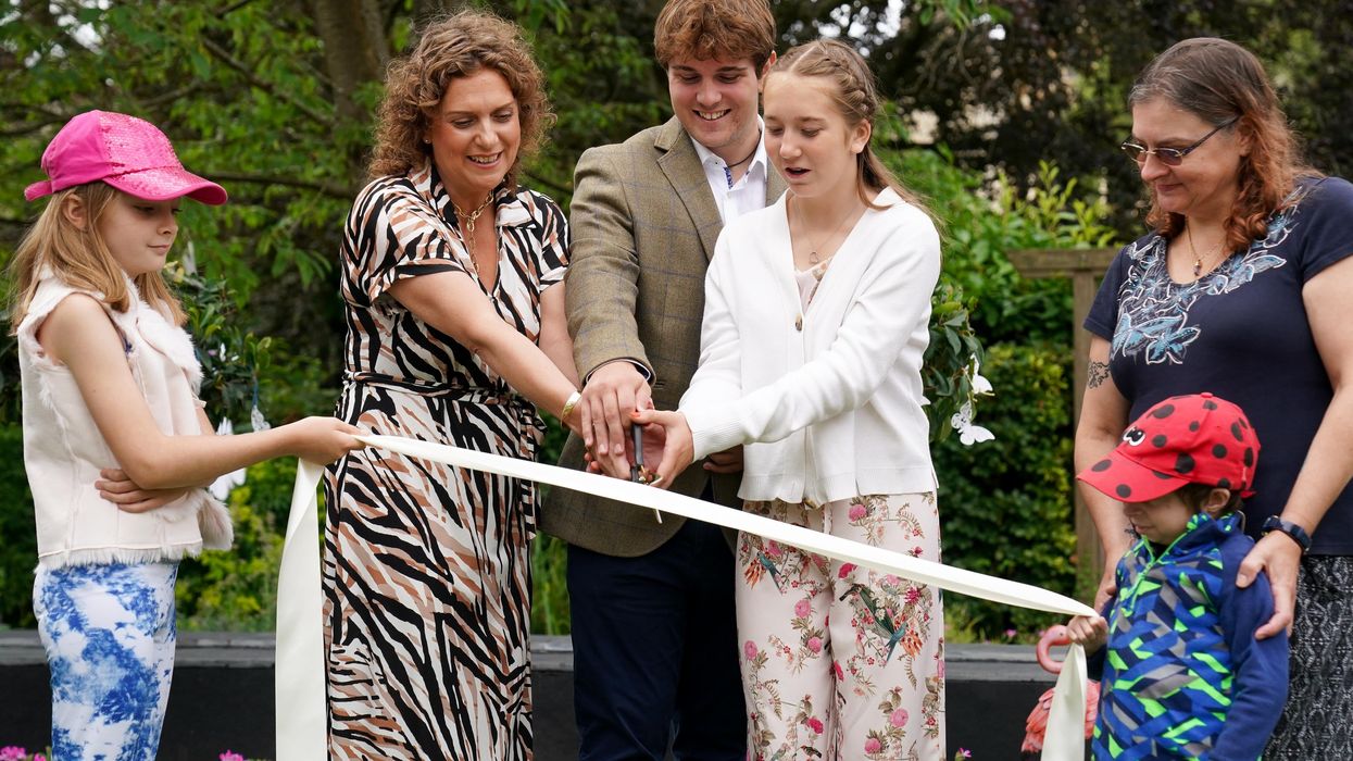Captain Sir Tom Moore’s daughter Hannah Ingram-Moore alongside his grandchildren Benjie Ingram-Moore and Georgia Ingram-Moore officially open a new garden at the Helen and Douglas House children’s hospice in Oxford (Jacob King/PA)