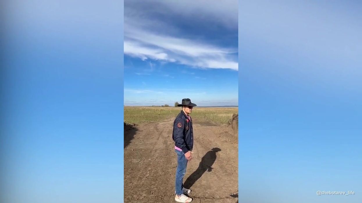 Moment car flawlessly knocks bottle off man's head in insane stunt