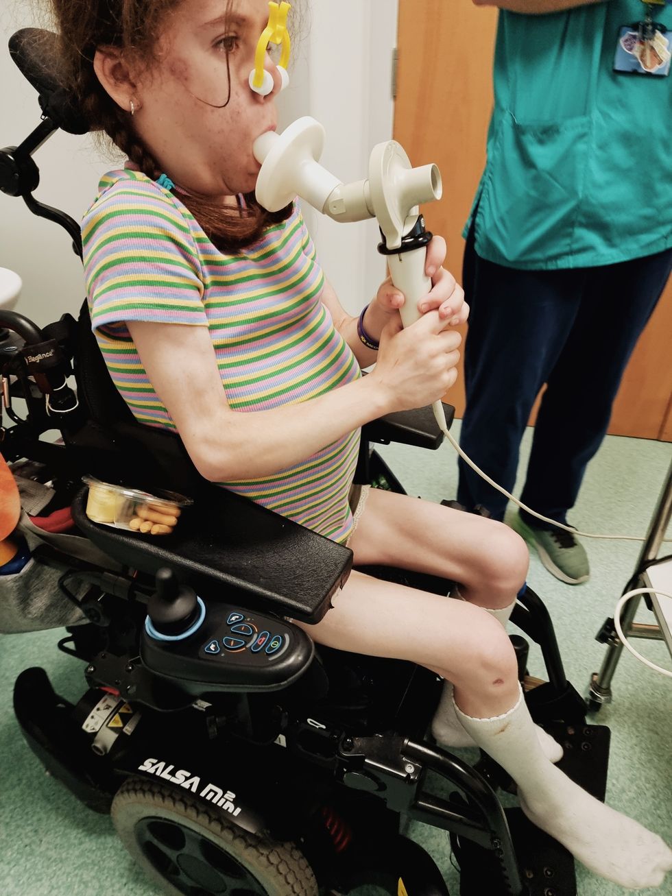 Carmela sitting in her wheelchair