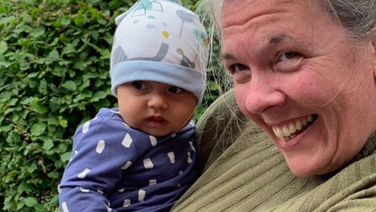 Carolyn Webster meets an interpreter she helped flee Afghanistan and his family (Sayed/PA)