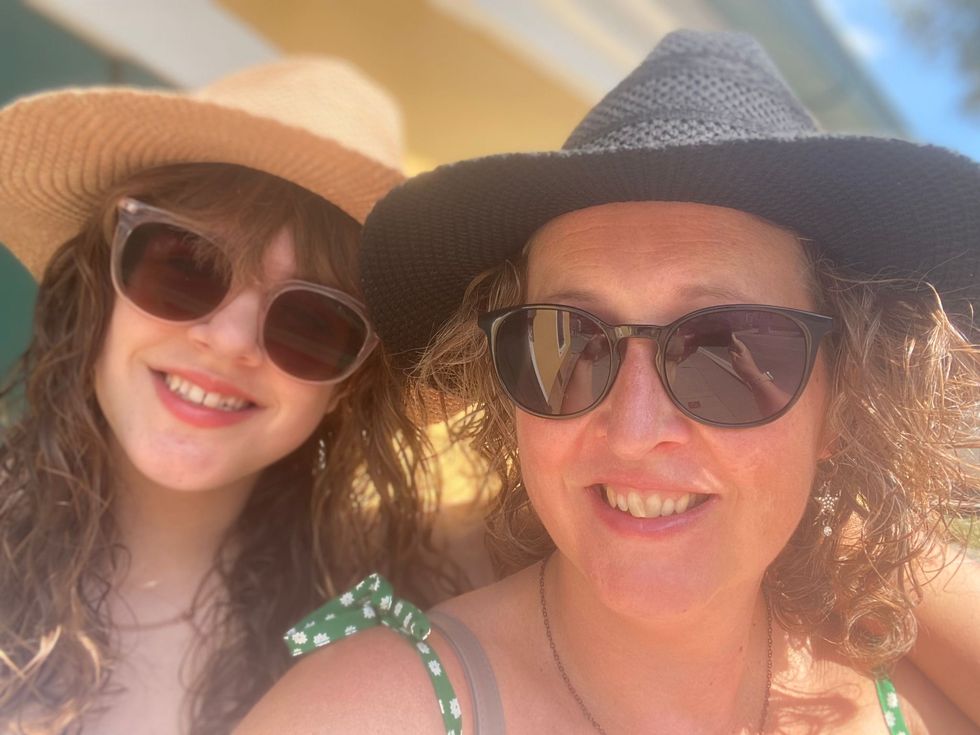 Catherine and Carla Santamaria wearing sunglasses and smiling at the camera
