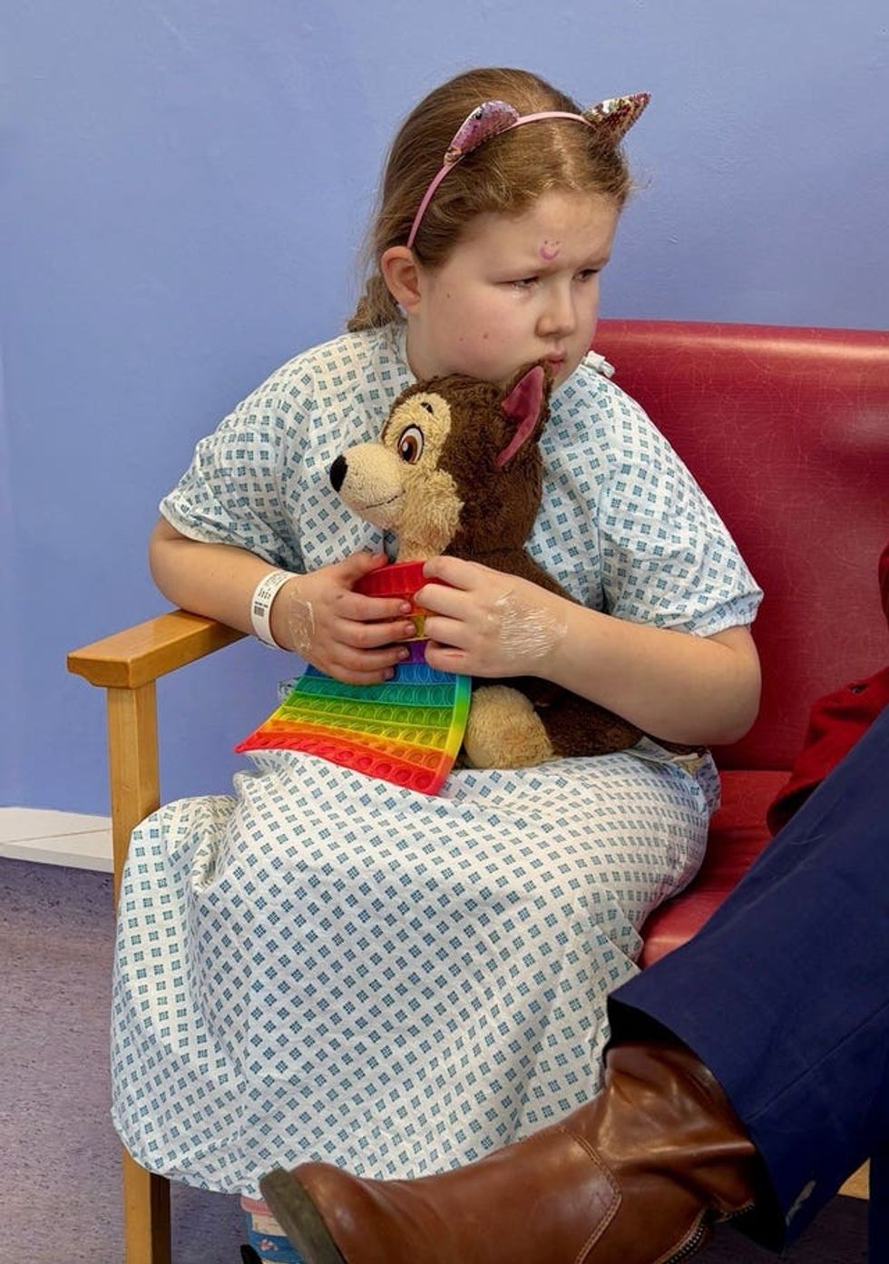 Catherine L\u2019Estrange holding a teddy in a hospital gown