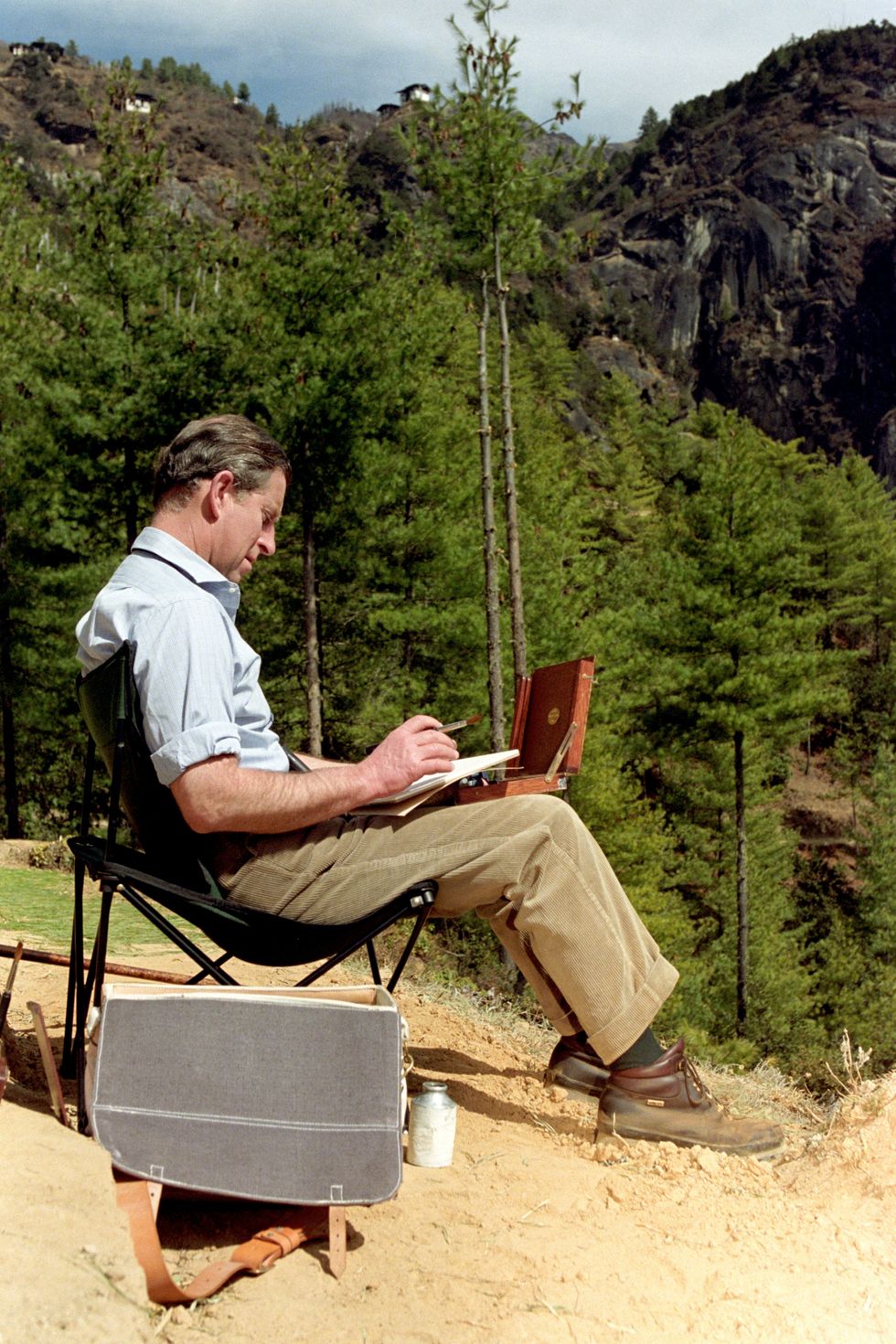 Charles painting in Paro, Bhutan, while on a royal visit in 1998 (John Stillwell/PA)