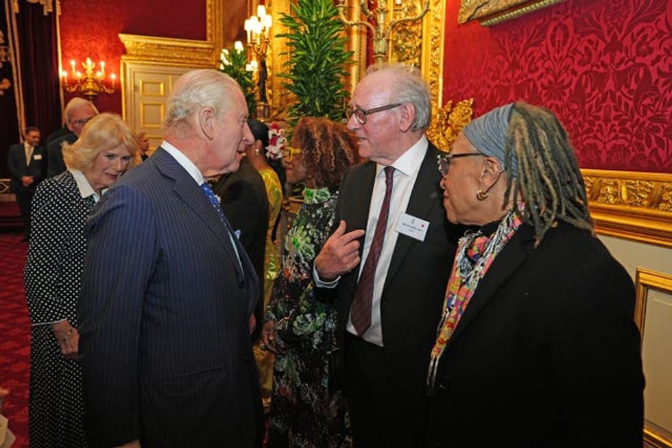 Charles speaking to actor Peter Davison during the reception