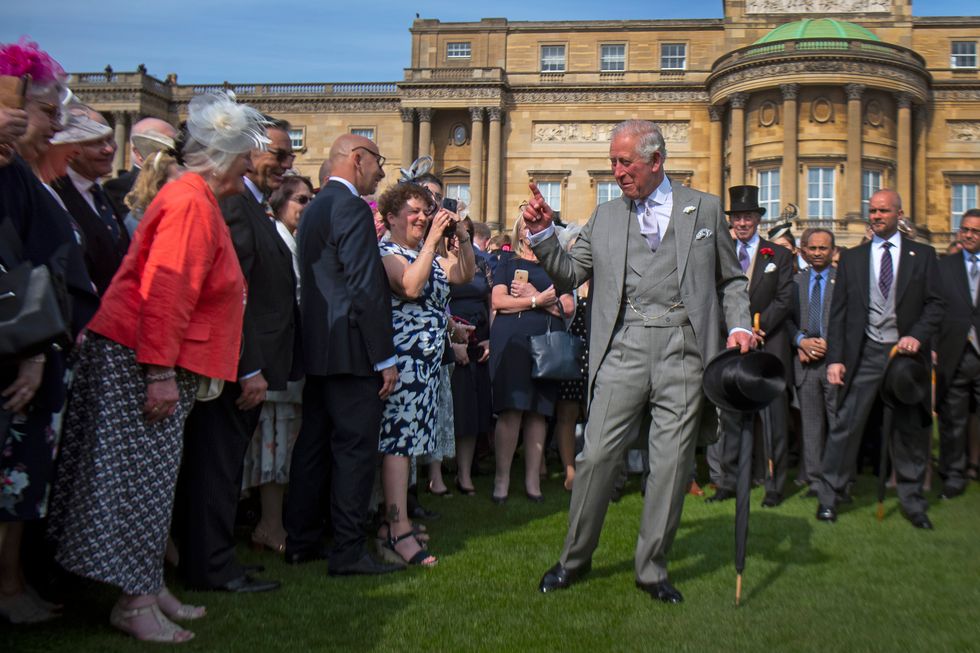 Charles sticking his finger out, with his other hand on a stick