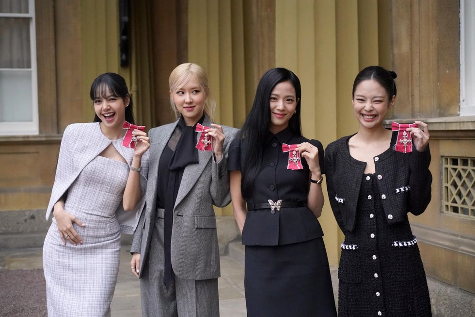 King presents K-pop band Blackpink with honorary MBEs at Buckingham Palace