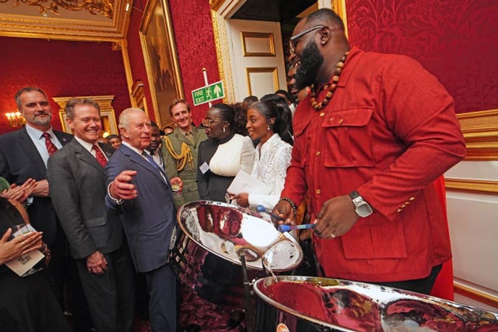 Charles watching Khan Cordice play the steel drums