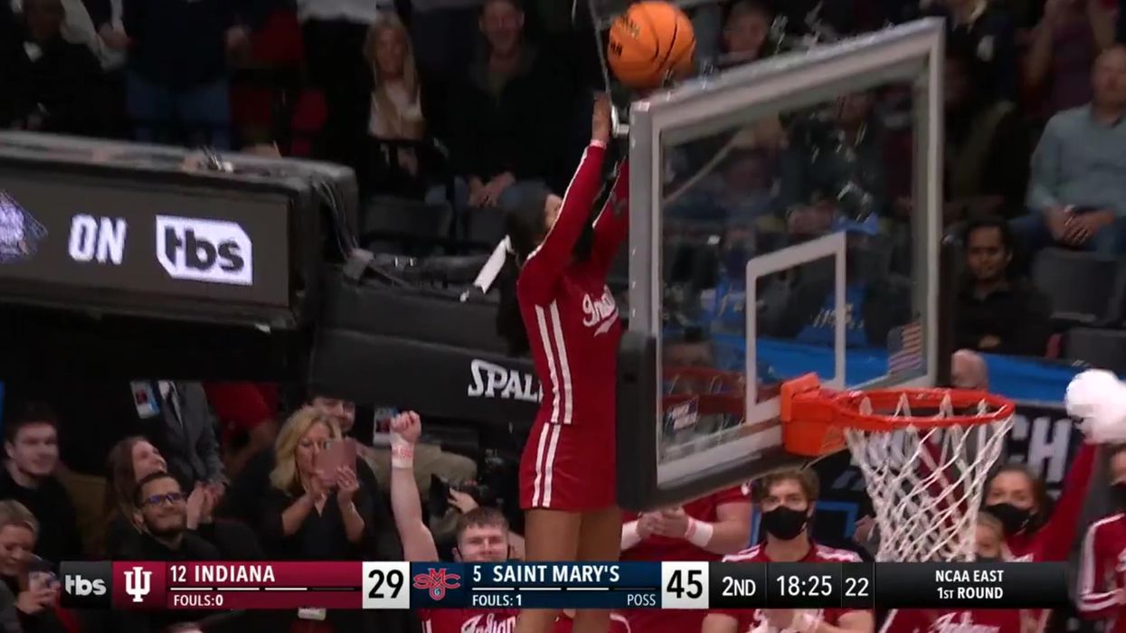Cheerleader saves basketball game in full arena as ball gets stuck