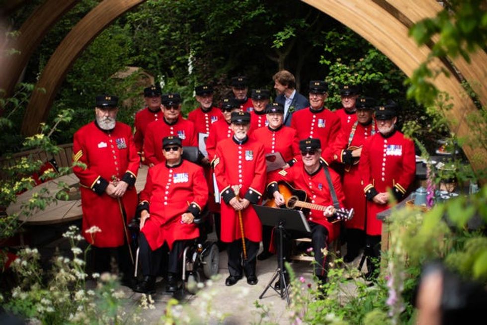 Chelsea Pensioners pose in one of the gardens