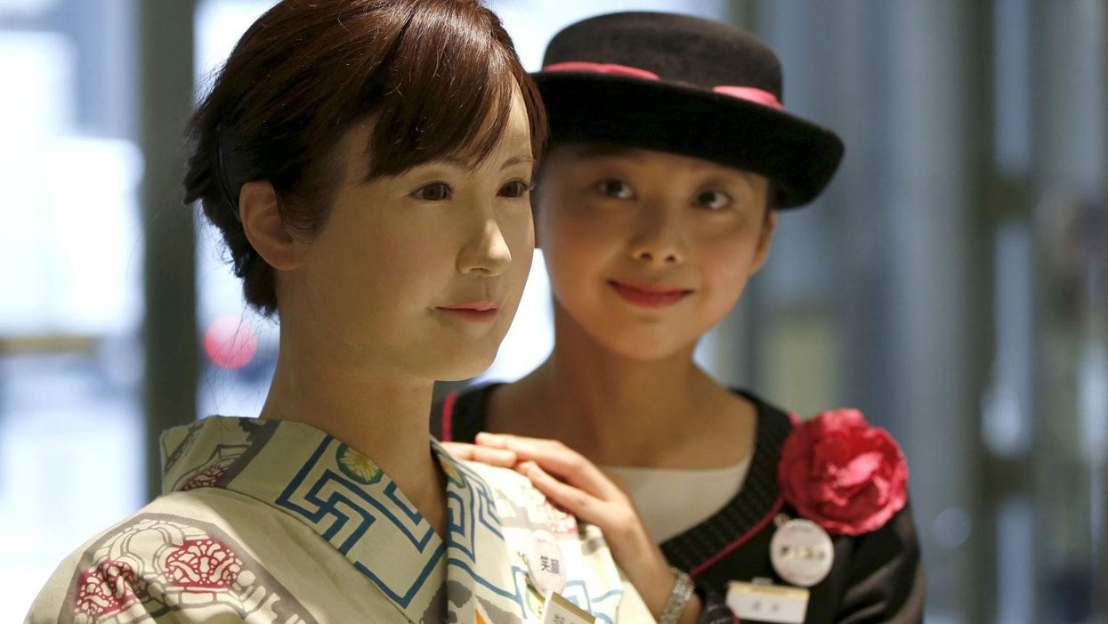 Chihira, left, with one of the store's human employees, right