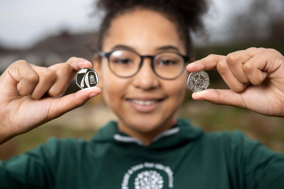 Children at Saltford C of E Primary School in Bristol with the new Platinum Jubilee 50p which will be gifted to 7,000 children completing the QGC Forestry Award. (PA)