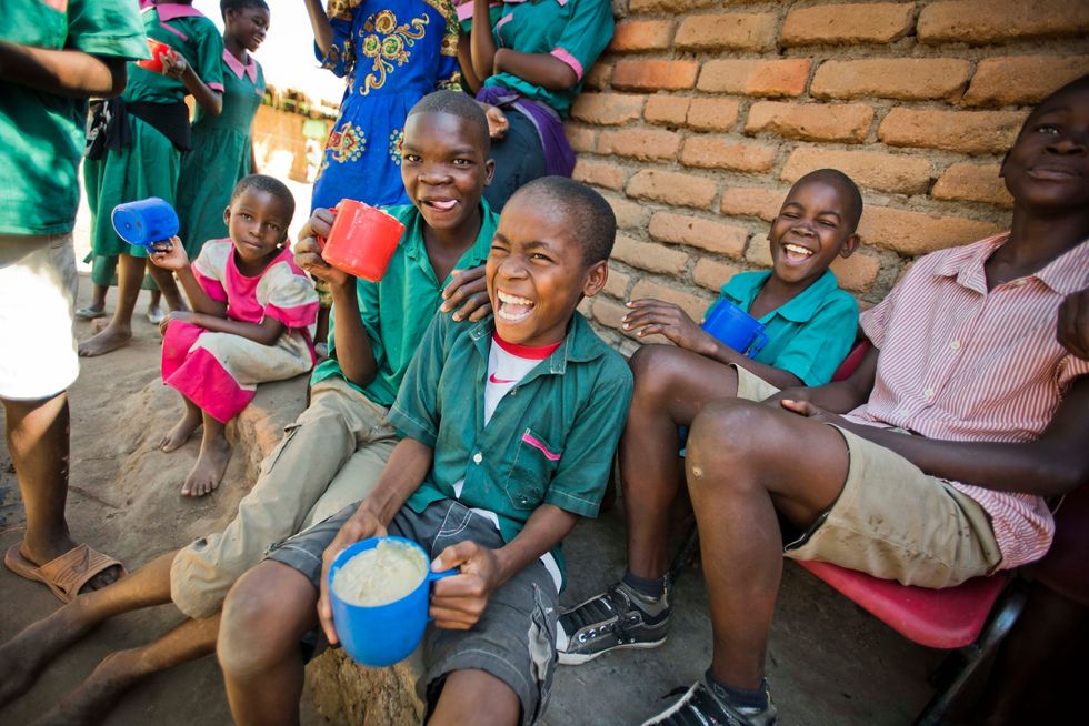 Children receiving a meal from Mary's Meals