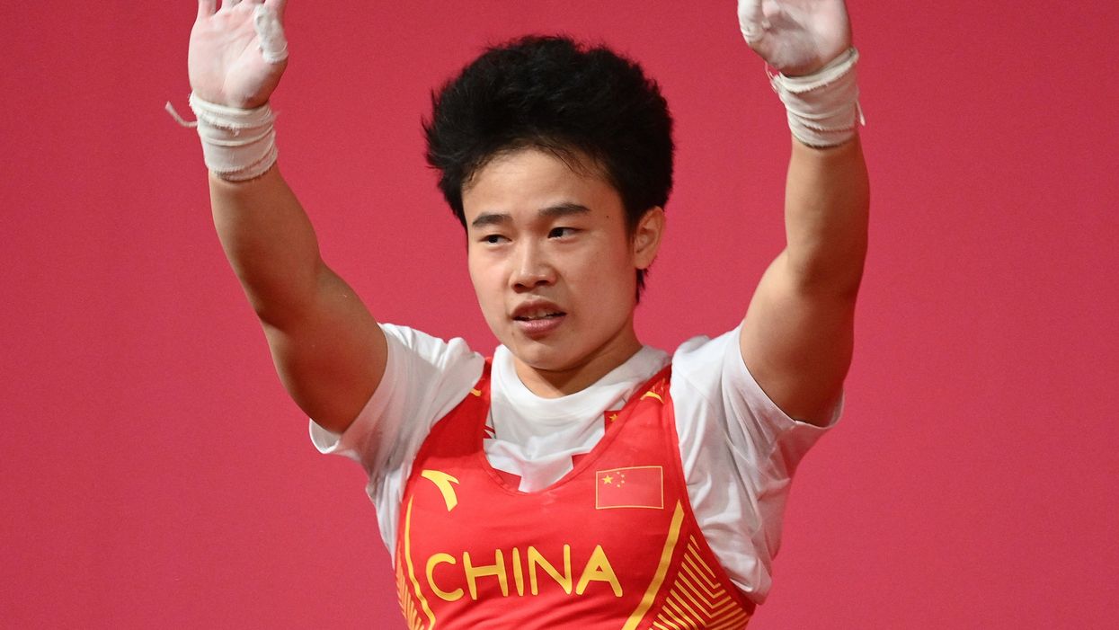 <p>China's Hou Zhihui competes in the women's 49kg weightlifting competition during the Tokyo 2020 Olympic Games at the Tokyo International Forum in Tokyo on July 24, 2021</p>