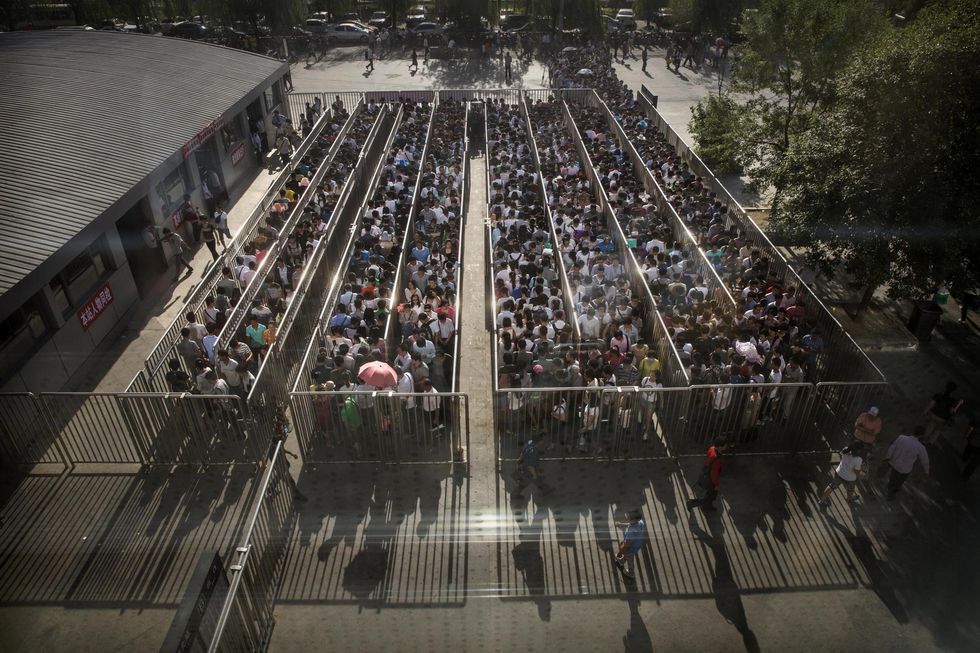 Chinese commuters line-up at a security check to enter a subway station on 29 May2014 in Beijing, China