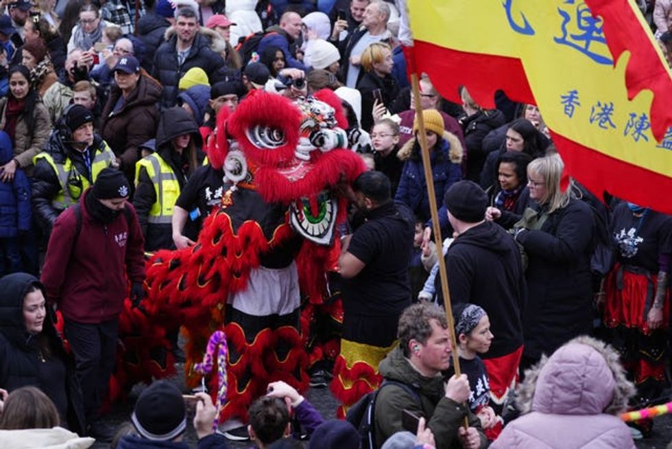 Chinese new year performers walk through crowds during the parade
