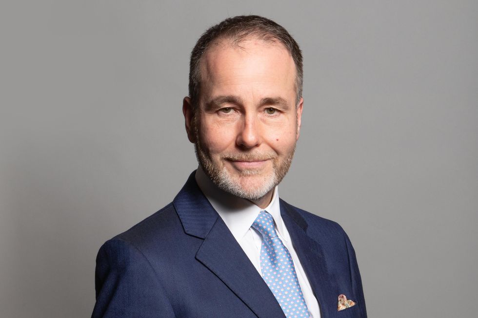 Chris Pincher, a white man with a short grey beard and short black hair. He has a large forehead and wears a navy suit.