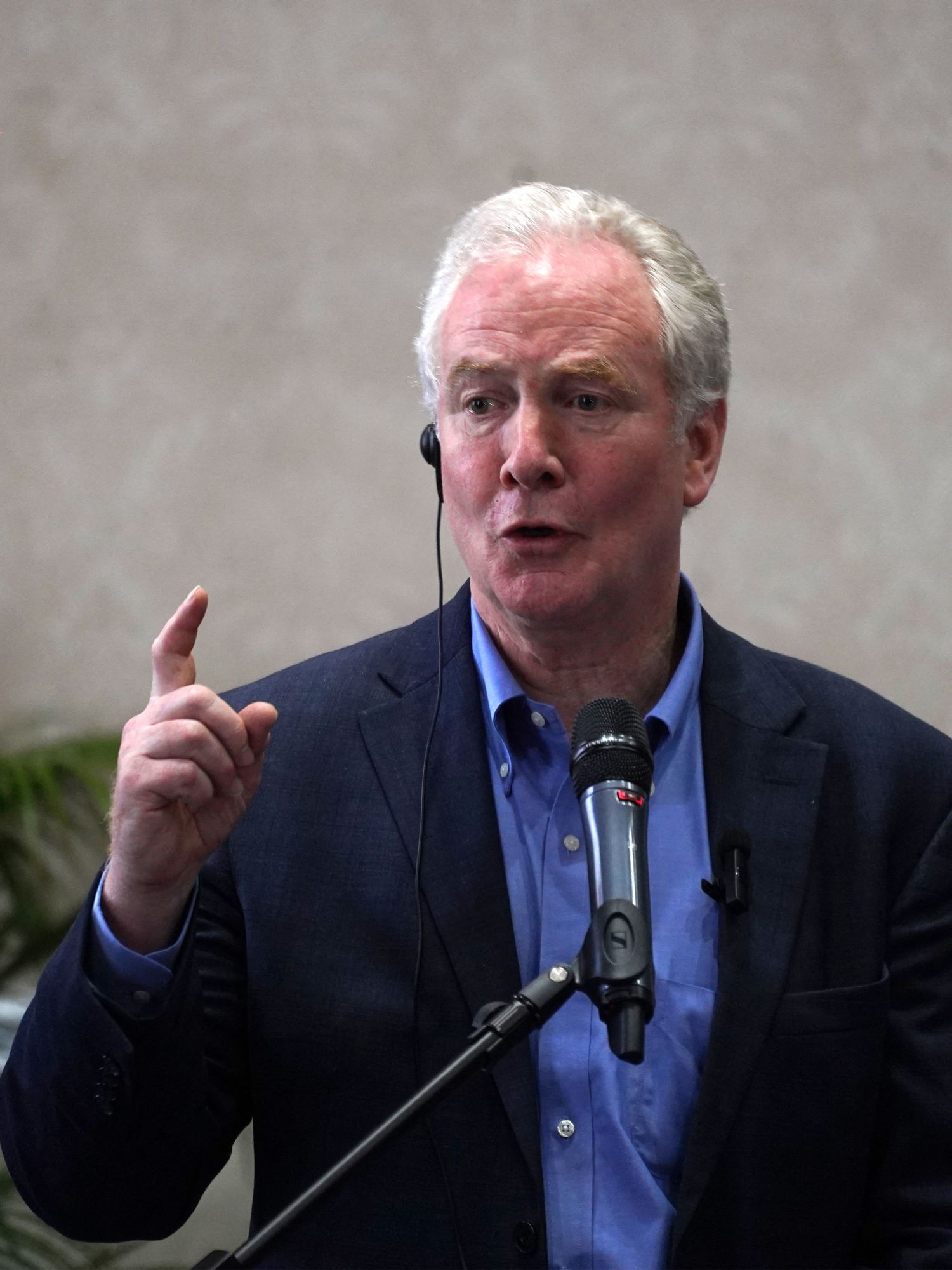 Chris Van Hollen, a white man with short white hair, holds a press conference in a hotel in El Salvador.