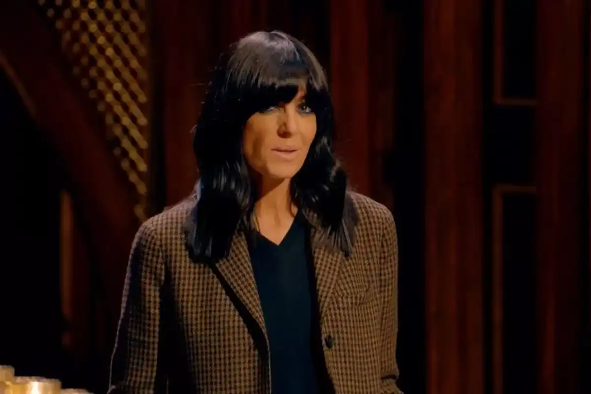 Claudia Winkleman wears a tweed blazer and looks into the camera in a screen grab from The Traitors