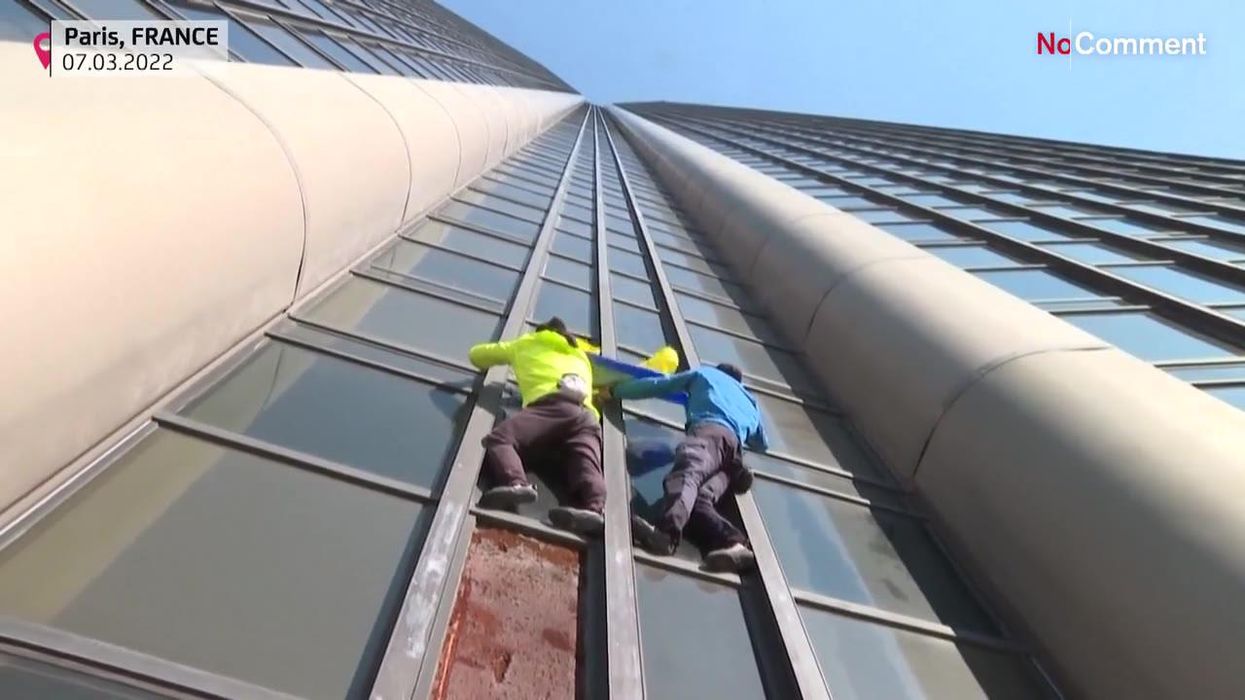 Climbers scale 210-metre skyscraper in support of Ukraine