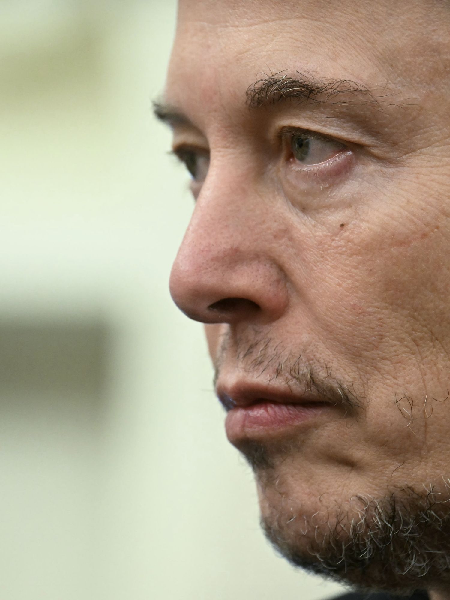 Close-up image of Elon Musk from the left-hand side.