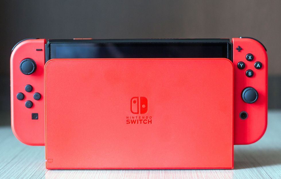 Close-up of a red Nintendo Switch console on a wooden surface stock photo