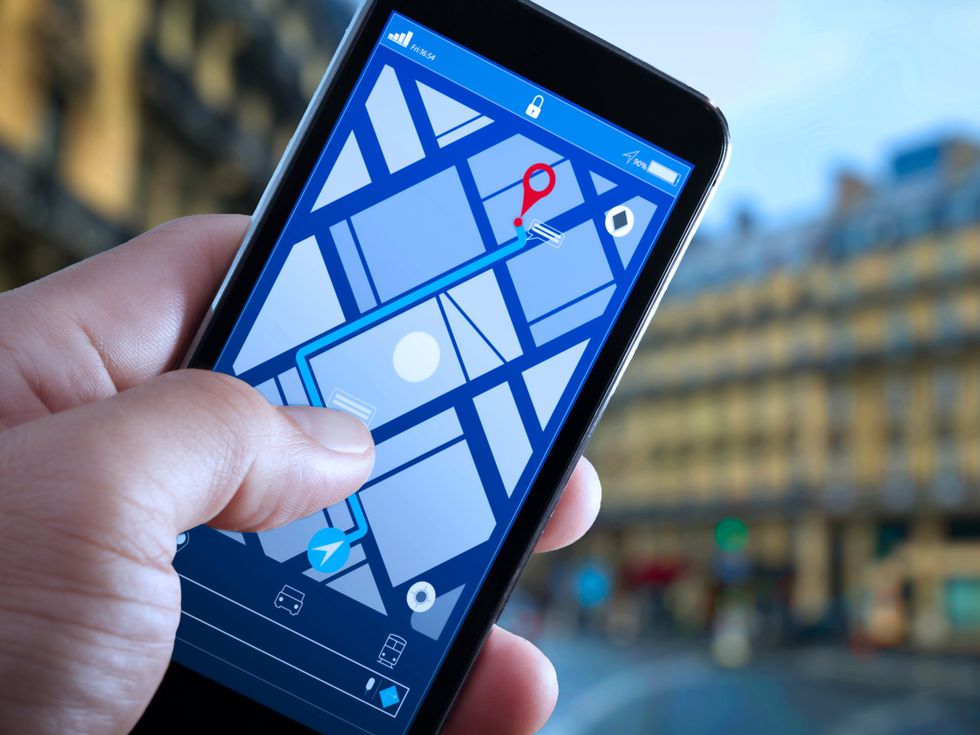 <p>Close up of Tourist using GPS map navigation on smartphone application screen for direction to destination address in the city with travel and technology concept.</p>