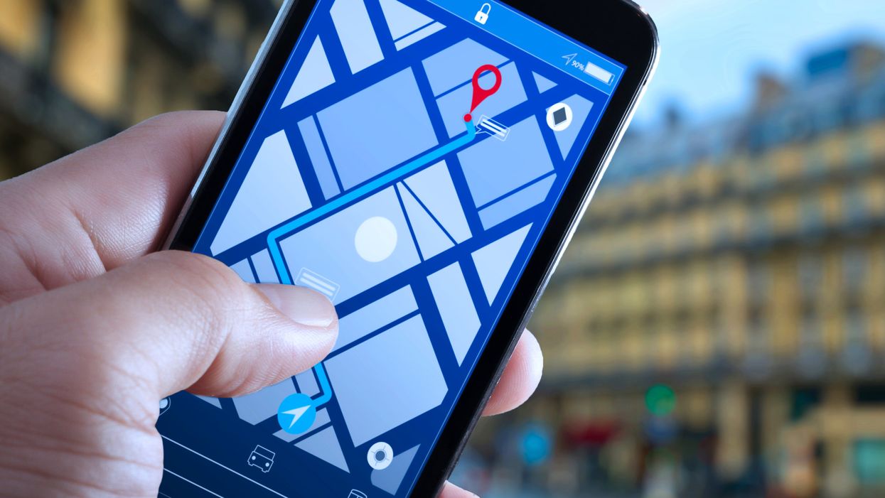 <p>Close up of Tourist using GPS map navigation on smartphone application screen for direction to destination address in the city with travel and technology concept.</p>