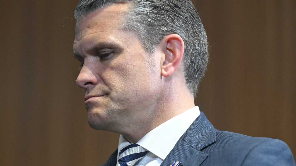 Close-up photo of Pete Hegseth, a white man with short grey hair and a blue suit.