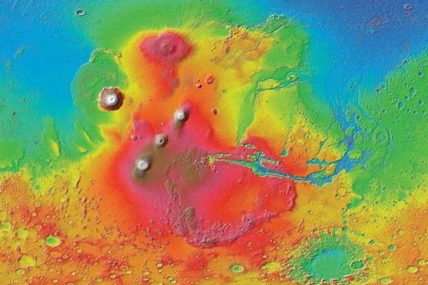 Colourised image of the surface of Mars showing three volcanoes of the Tharsis Montes region, with Olympus Mons to the northwest