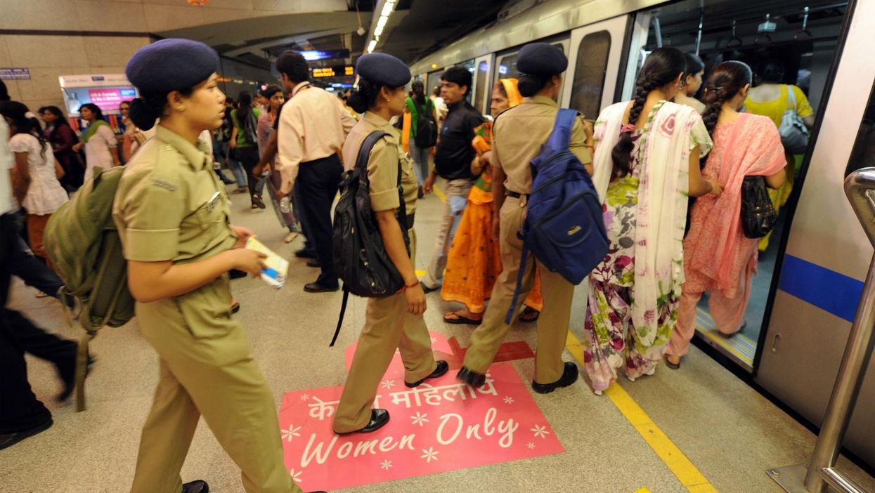 Commuters board a women-only train carriage in New Delhi, India, on October 2nd, 2010.