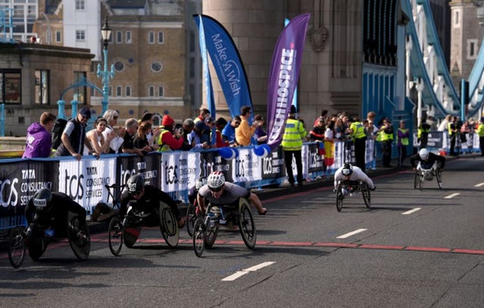 Competitors in the men's wheelchair London Marathon cross Tower Bridge