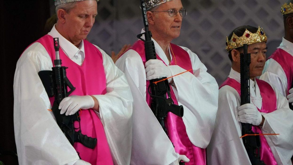 Congregants at World Peace and Unification Sanctuary hold weapons during their service