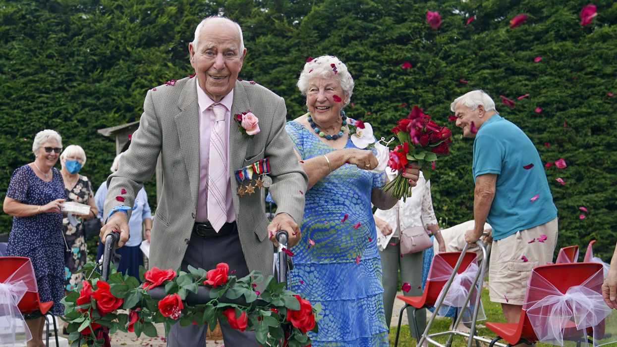 Couple in their 90s walk down the aisle after renewing their wedding blessings.