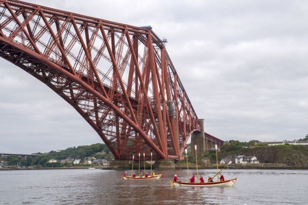 Crews from the Queensferry Rowing Club give an oar salute to the crew of ROW4MND