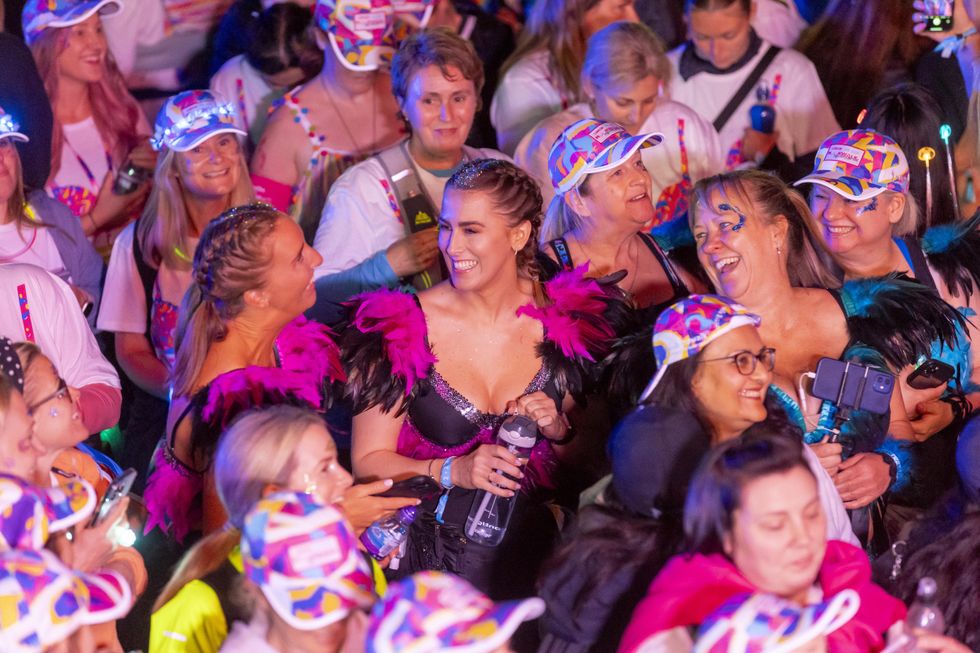 Crowd of women dressed in decorated bras for charity event