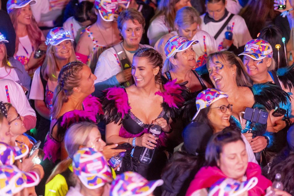 Crowd of women dressed in decorated bras for charity event