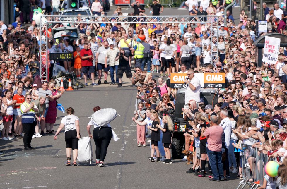 Crowds cheered on the sack-bearers (Jane Barlow/PA)
