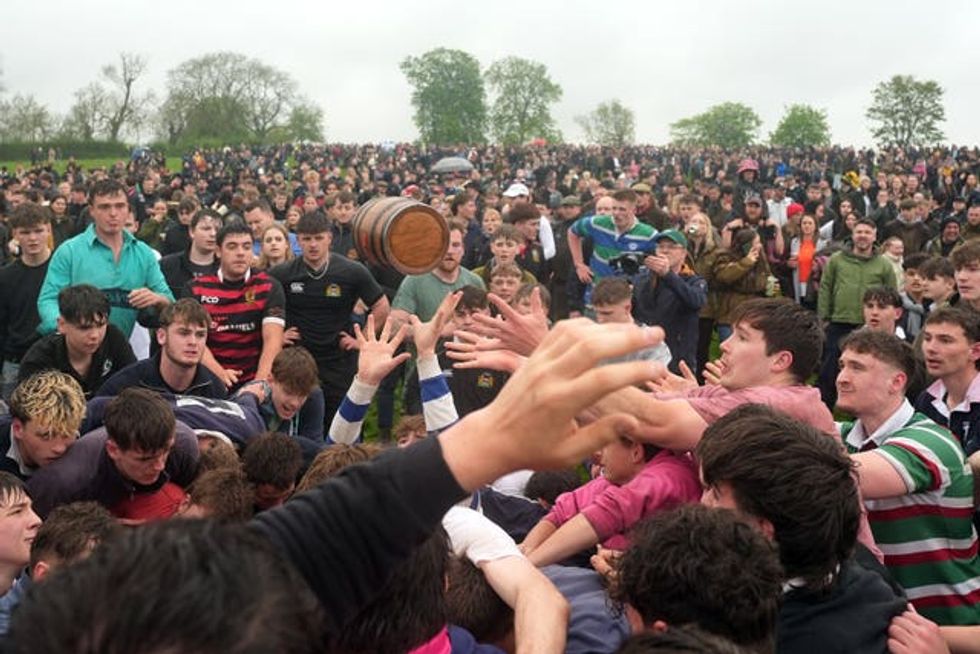 Crowds compete in the bottle-kicking event
