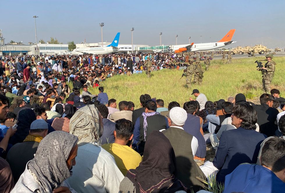 Crowds of people have travelled to the airport in Kabul hoping for a way out of the country (Shekib Rahmani/AP)