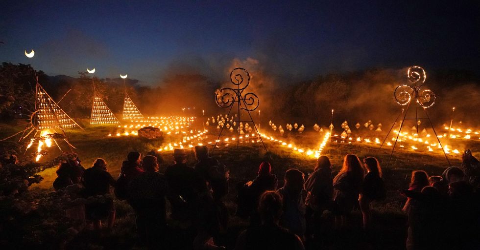 Spectators gather for ancient Celtic fire procession that welcomes summer