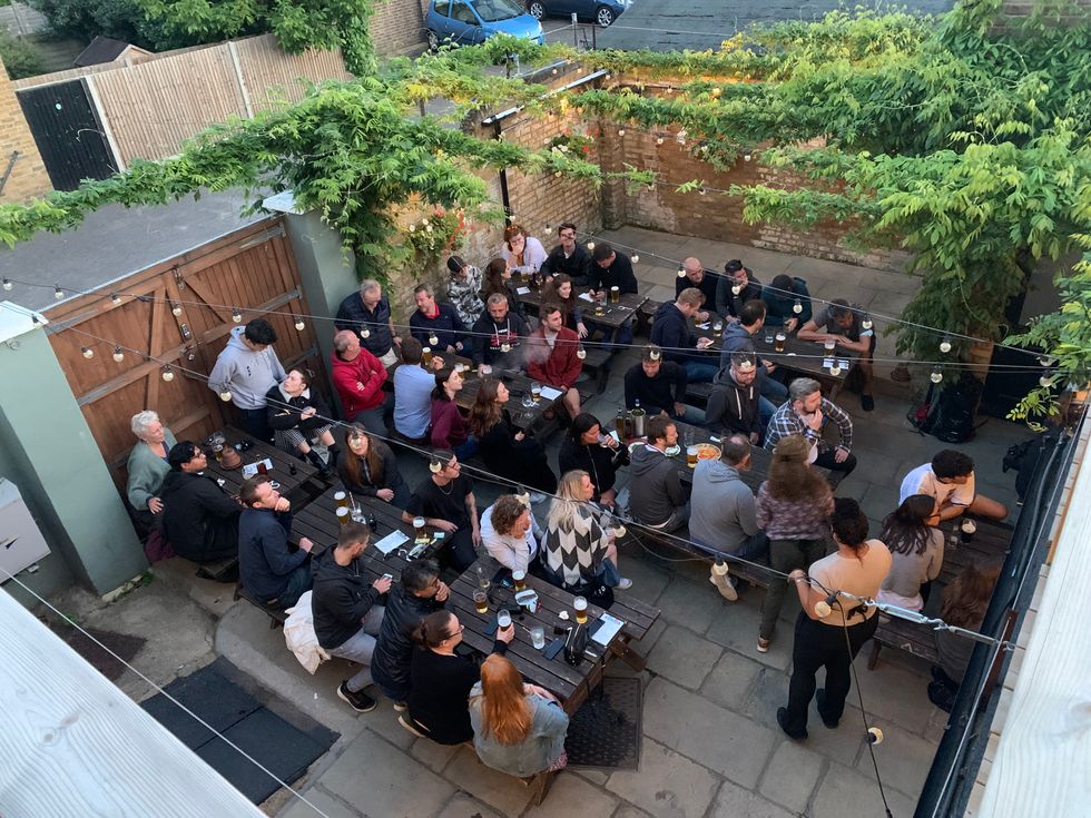 Customers sitting on benches at the Mitre pub